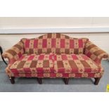 Mahogany upholstered scroll sofa raised on mahogany feet in red, brown and cream moquette.