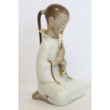 Danish Royal Copenhagen porcelain figure of an opium smoker or girl smoking a pipe, no. 2342,