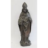 Antique carved oak figure of a bishop holding a book, 56cm high.