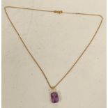 Gold pendant with rectangular amethyst and diamond, probably '14'.