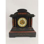 French rouge and black marble mantel clock of architectural form, with four columns. 37cm.