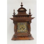 Junghams mantel clock with silvered and ivory dial, in walnut and rosewood case with turned columns.