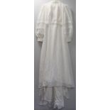 1960's wedding dress in white nylon with high lace ruffle neck, fitted princess line bodice, long