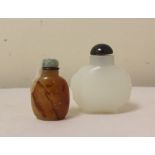 Two Chinese snuff bottles, one in white glass of bulbous form bearing taotie masks to sides, the