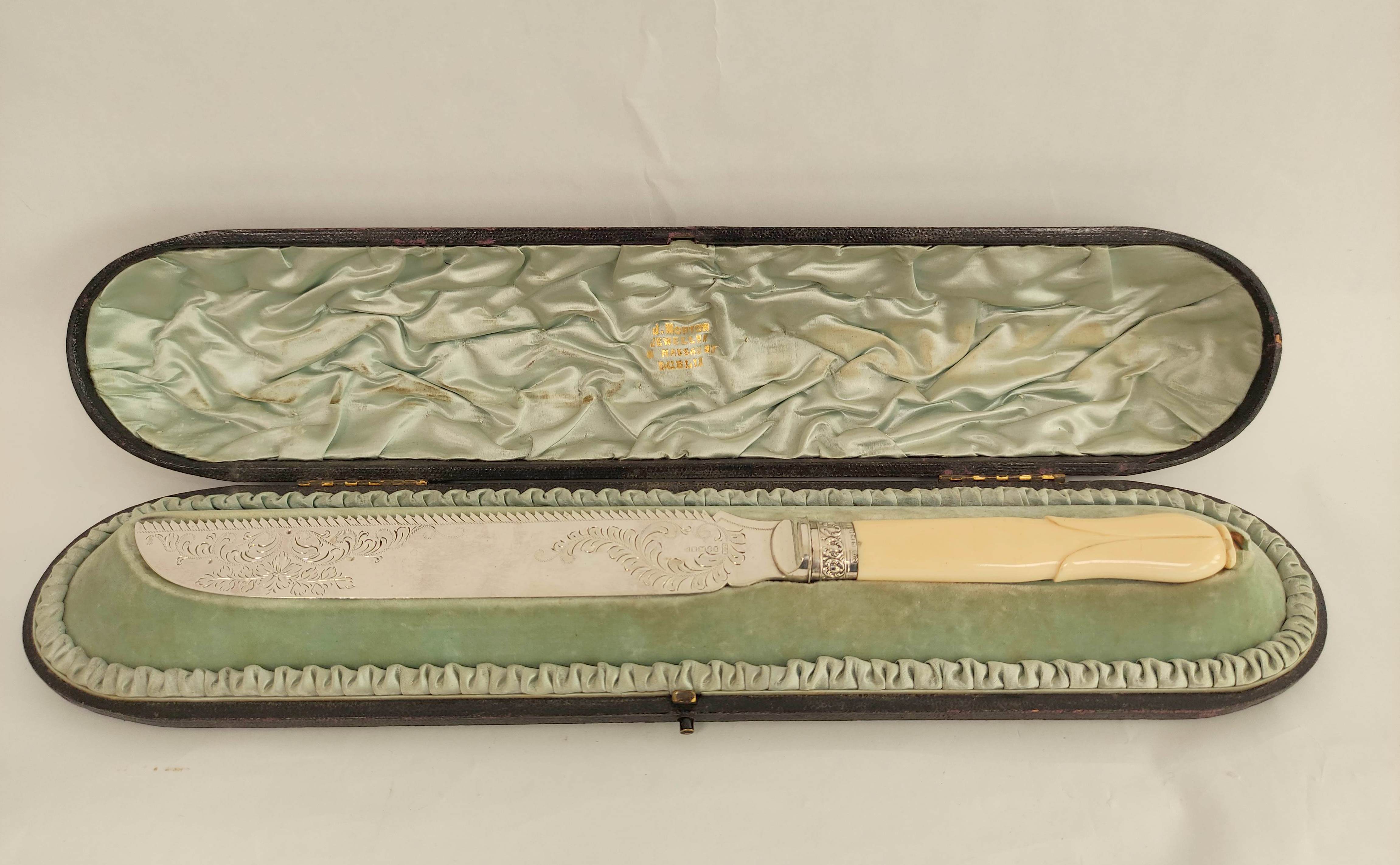 Good e.p. cake knife, engraved with carved ivory handle, the silver ferrule Sheffield 1897, cased.