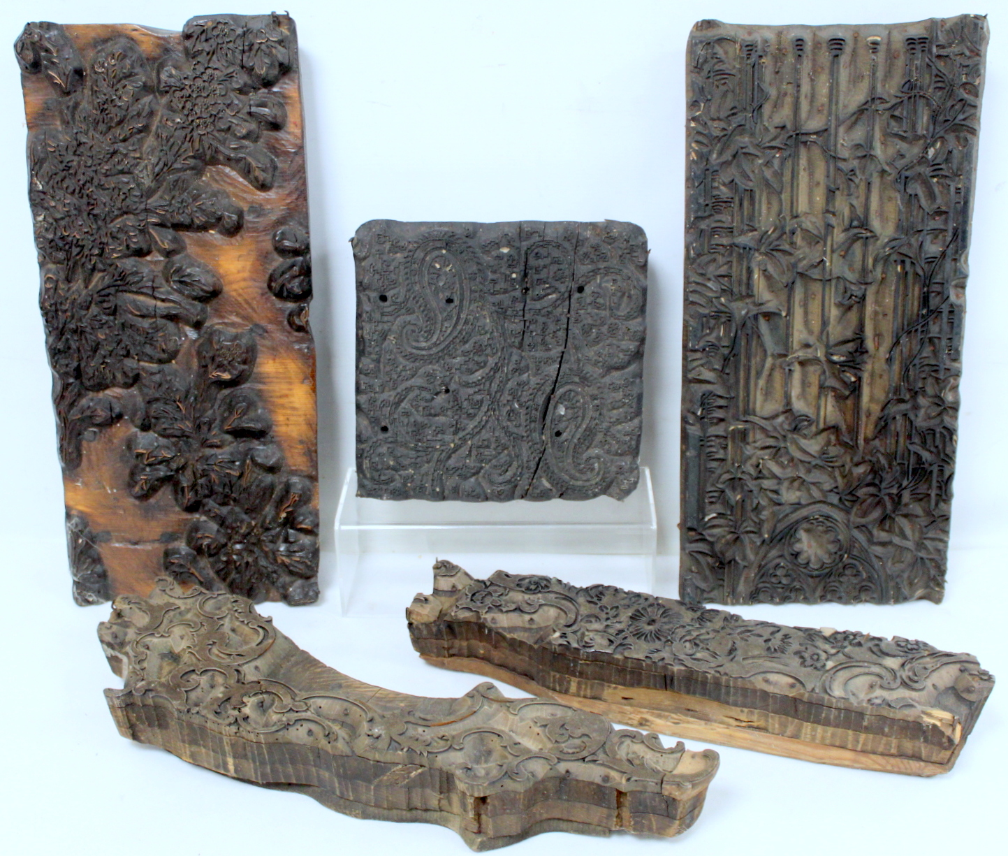 Five various 19th century wooden textile printing blocks: one of square form with paisley pattern