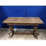 Oak refectory draw leaf dining table, the draw leaf plank top above a carved frieze, raised on