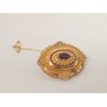 Victorian gold mourning brooch with oval garnet.