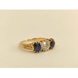 Edwardian gold ring with diamond brilliant approx. .75ct and two sapphires in engraved gold,