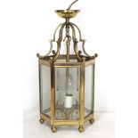 Georgian style brass hall lantern of hexagonal form with bevelled glass panels, domed scroll