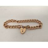 Gold hollow curb bracelet with padlock by Grinsells 9ct, 9g.