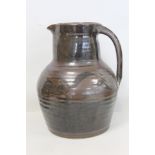 Harry and May Davis Crowan Cornish studio pottery jug of baluster form with tenmoku glaze, with