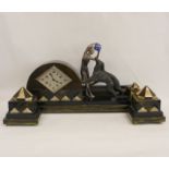 Art Deco garniture comprising a timepiece in arched case with flanking figure and two dogs, with