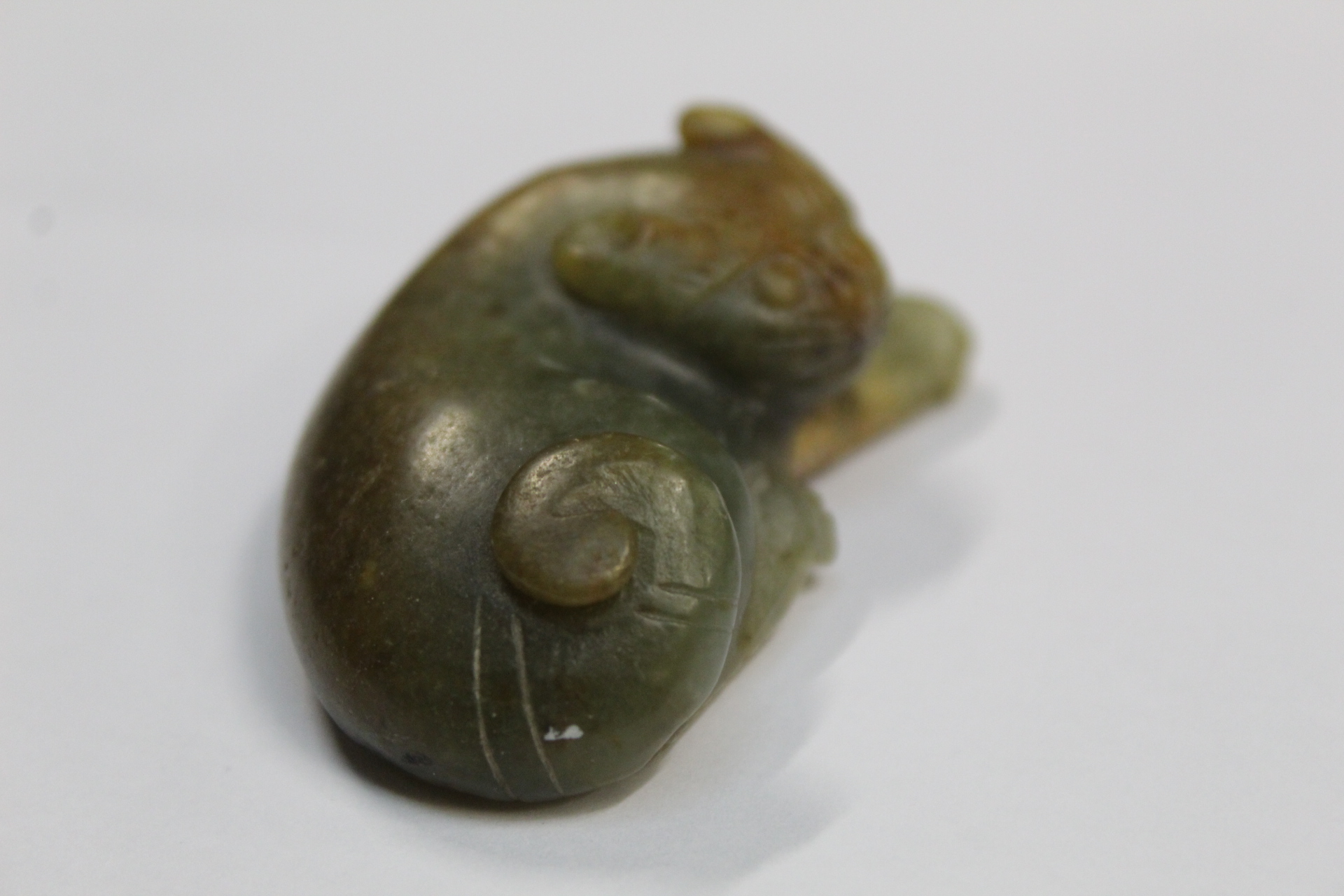Three Chinese archaic and archaised jade figures to include a repose cat figure, a rectangular - Image 7 of 14