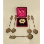 Five Indonesian silver coffee spoons and a delicately carved ivory brooch depicting a deer.