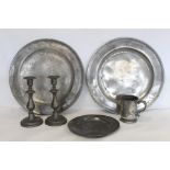 Two large circular pewter chargers, each 42cm diam., with stamped initials M.R.D. (one split); a