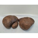 Pair of early 20th century Frank Bryan Ltd leather straw filled boxing gloves with cross tied