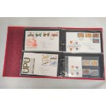 Two albums of approximately 134 Royal Mail first day cover postage stamp sets dating from the