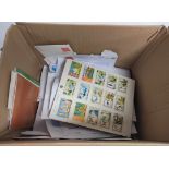 Box containing a large collection of world postage stamps each sorted into its subsequent country to