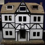 Vintage child's doll's house in need of restoration with traces of electric fittings and balsa