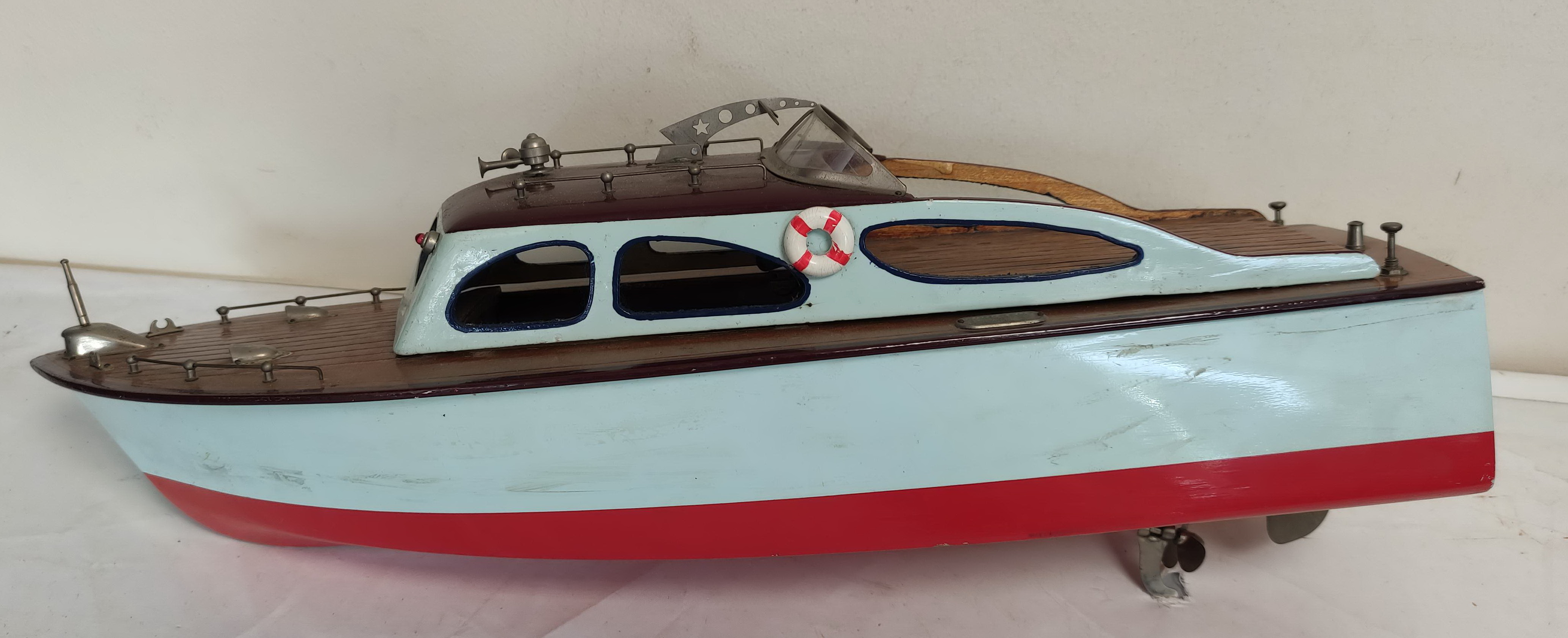 Vintage wooden painted model boat with electric motor.