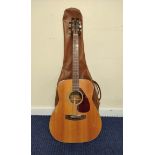 Yamaha FG-160 acoustic guitar in brown leather case.