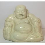 Oriental white glazed pottery figure of Buddha or Hotei, seated and smiling, 17cm high.