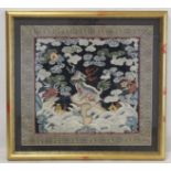 19th or early 20th century Chinese embroidered silk panel depicting a Dog of Fo on rock amongst