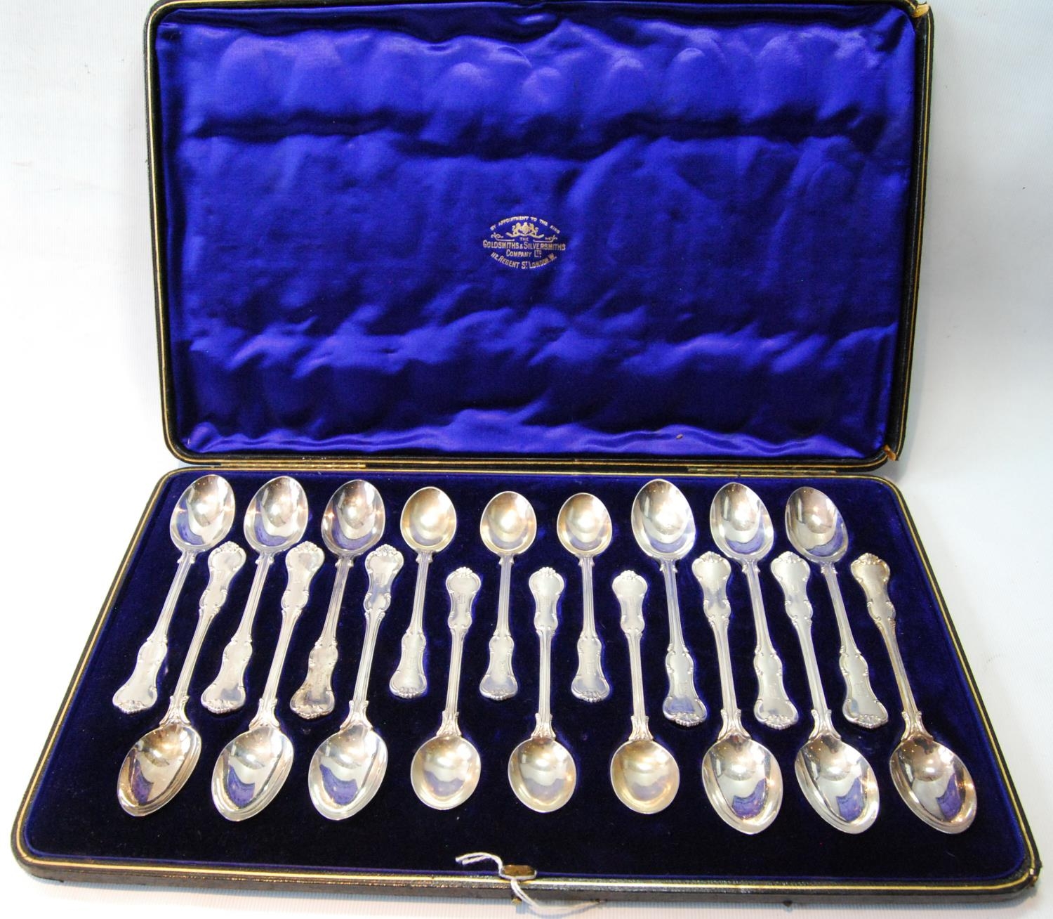 Set of twelve silver teaspoons with scroll borders with six matching coffee spoons, by The