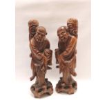 Pair of Chinese carved fruitwood figures of the twins He-He Er Xian, each holding a box and standing