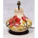 Moorcroft table lamp decorated with hibiscus pattern on a cream ground, 25cm high.