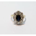Large cluster ring with oval sapphire and eight diamond brilliants, each approximately .25ct, in