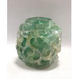 Chinese green rock crystal vase of cylindrical form, deeply carved with scrolling foliage, drilled