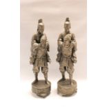 Pair of late 19th/early 20th century Japanese white metal figures of samurai carrying shoguns,