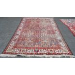 Persian Bakhtiari rug decorated with nine rows of five floral and geometric motifs on a multi-