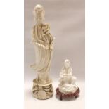 Chinese Blanc de Chine figure of the deity Guanyin holding a Ruyi sceptre seated on a naturalistic