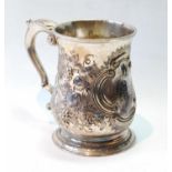 Silver mug of baluster shape, later embossed with scrolls and fruiting vines, maker probably