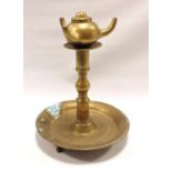 Brass candlestick with circular drip tray, on turned baluster column and dished circular base, three