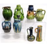 Collection of slipware vases including Ewenny-style vases glazed in green and blue, some examples