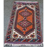 Afghan Belouch hand-knotted rug decorated with two geometric medallions to the centre, on an