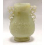 Chinese pale green hardstone vase of twin-handled oval baluster form with two carved archaic panels,