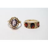 Amethyst ring, in 9ct gold, and a similar garnet ring, sizes M and L.  (2)