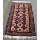 Afghan Belouch hand-knotted rug decorated with geometric medallions and panels of birds to the