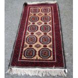 Afghan Belouch hand-knotted rug decorated with five rows of two geometric medallions, on a beige