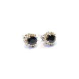 Pair of sapphire doublet and diamond cluster ear studs, in white gold.