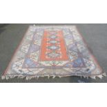 Turkish rug with five matching geometric medallions to the centre, on a pink ground, further all-