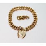 Gold hollow curb bracelet with engraved padlock, 1903, '15c', with spare links, 20g.