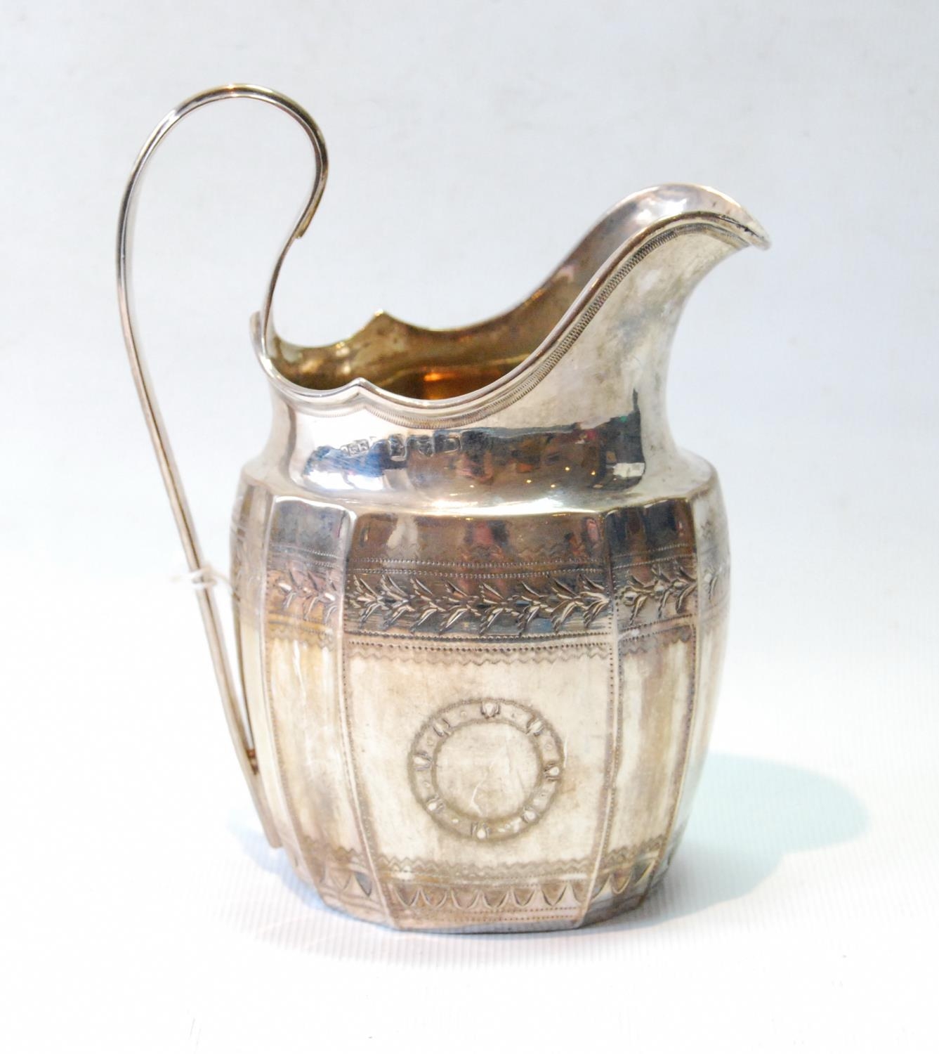 Silver cream jug of panelled ovoid shape, fluted corners and engraved bands, maker C & B (untraced),