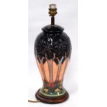 Moorcroft table lamp in the Art Deco style, with multi-coloured ground, 27cm high.