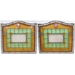 Pair of leaded stained glass windows of arched rectangular form with central rectangular panel, four